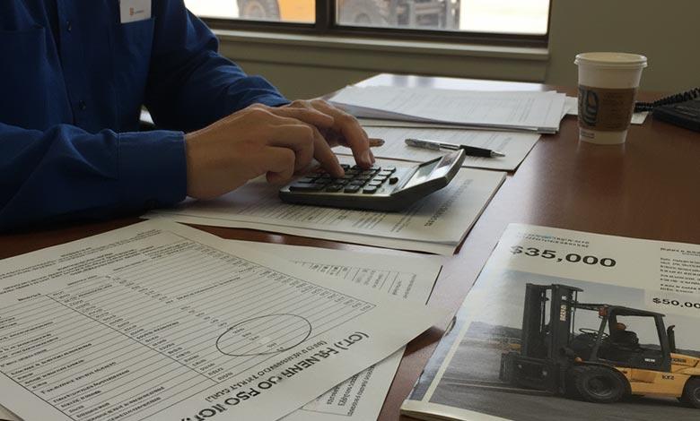 A manager reviewing charts and calculating total cost of ownership