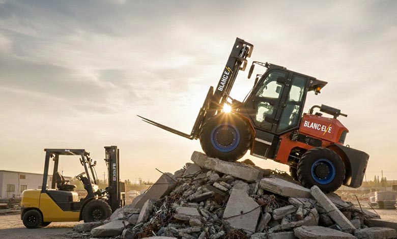 A BLANC-ELE rough terrain forklift easily driving over a large obstacle that a standard forklift could not.
