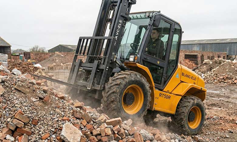 BLANC-ELE 4WD Forklift Solving Yard Problems A BLANC-ELE 4WD rough terrain forklift confidently driving over a pile of broken bricks and gravel.