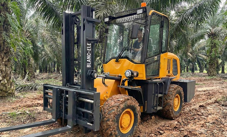 A rough terrain forklift turning sharply between rows of trees, demonstrating its maneuverability.