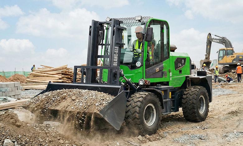 BLANC-ELE rough terrain forklift equipped with a bucket attachment working outdoors