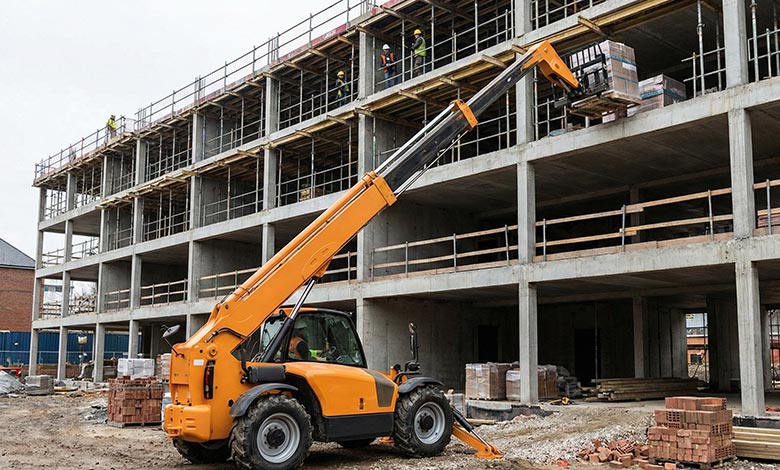 telehandler lifting construction materials to upper level, showing extended boom and high reach capability