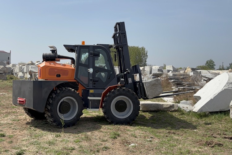 Rough terrain forklift working on outdoor stone yard ground