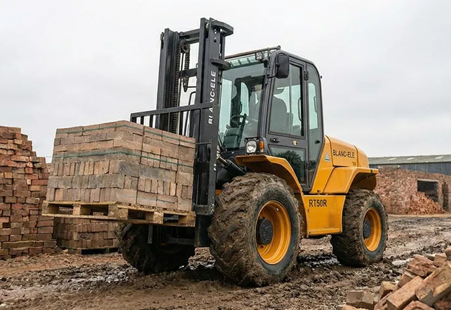 Rough terrain forklift handling palletized materials on uneven outdoor ground