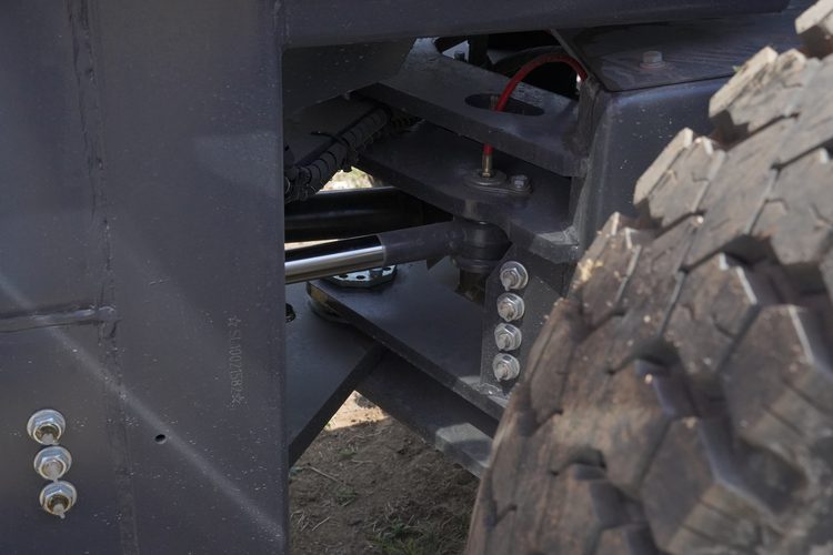 Rough terrain forklift tire and steering detail for outdoor route work