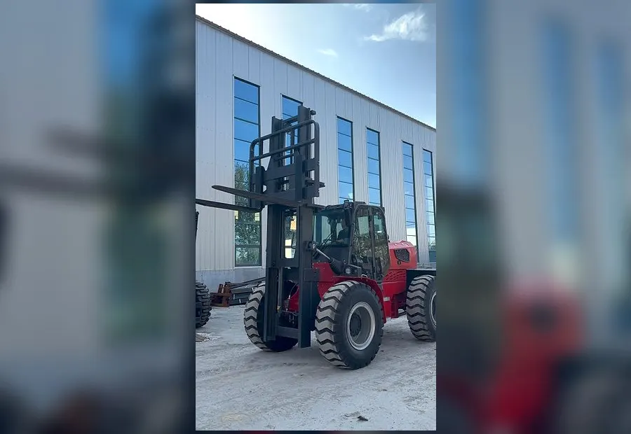 BLANC-ELE RT70 rough terrain forklift with forks raised outside the factory