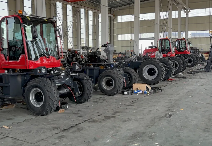 Rough terrain forklifts lined up in the factory before final configuration checks