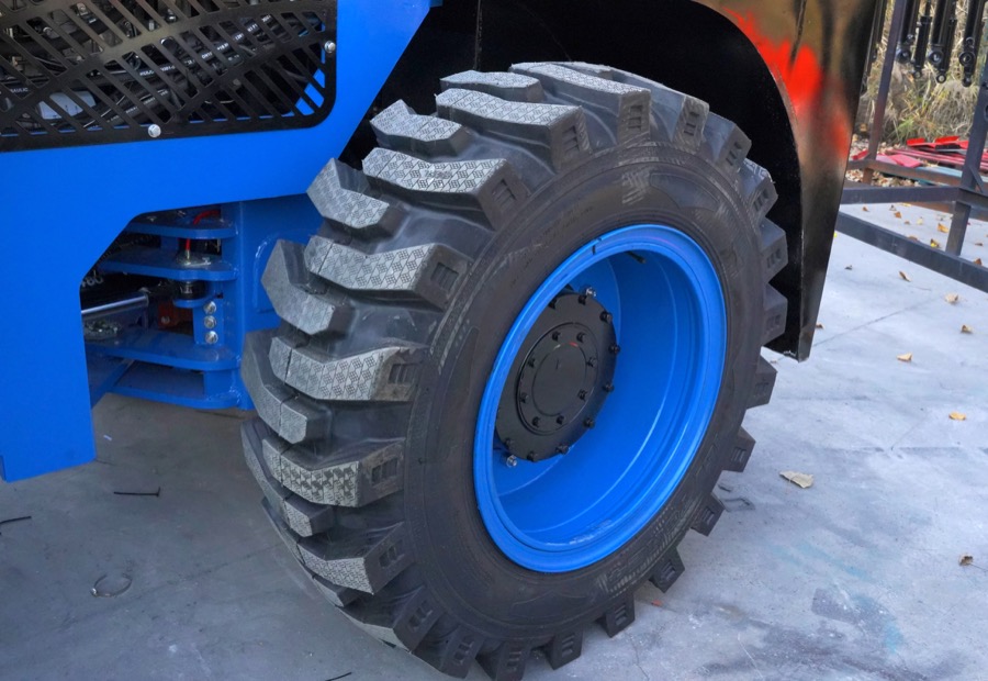 Rough terrain forklift tire detail for outdoor warehouse yard routes