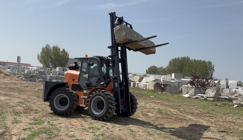 A BLANC-ELE RT50 rough terrain forklift in an outdoor stone-handling application.